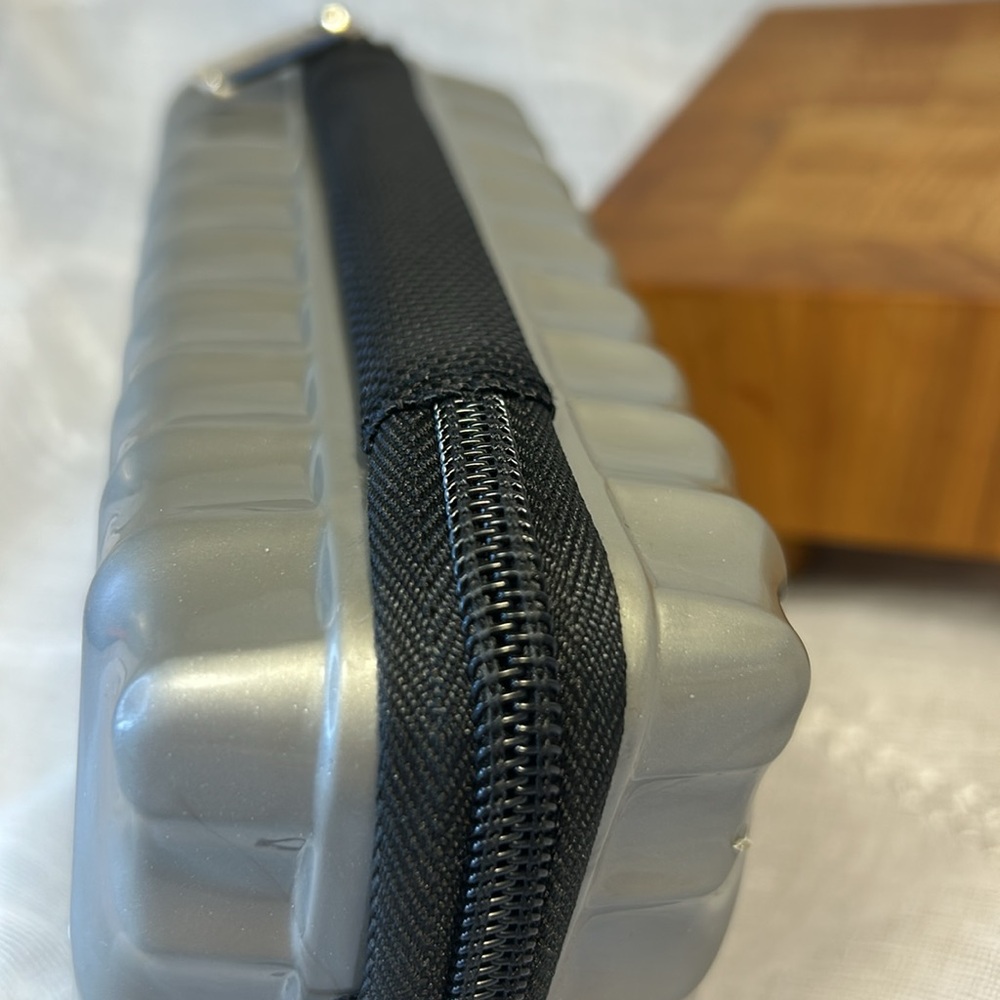 Tumi hard case luggage cosmetic bag filled with goodies for your next trip - Picture 9 of 10